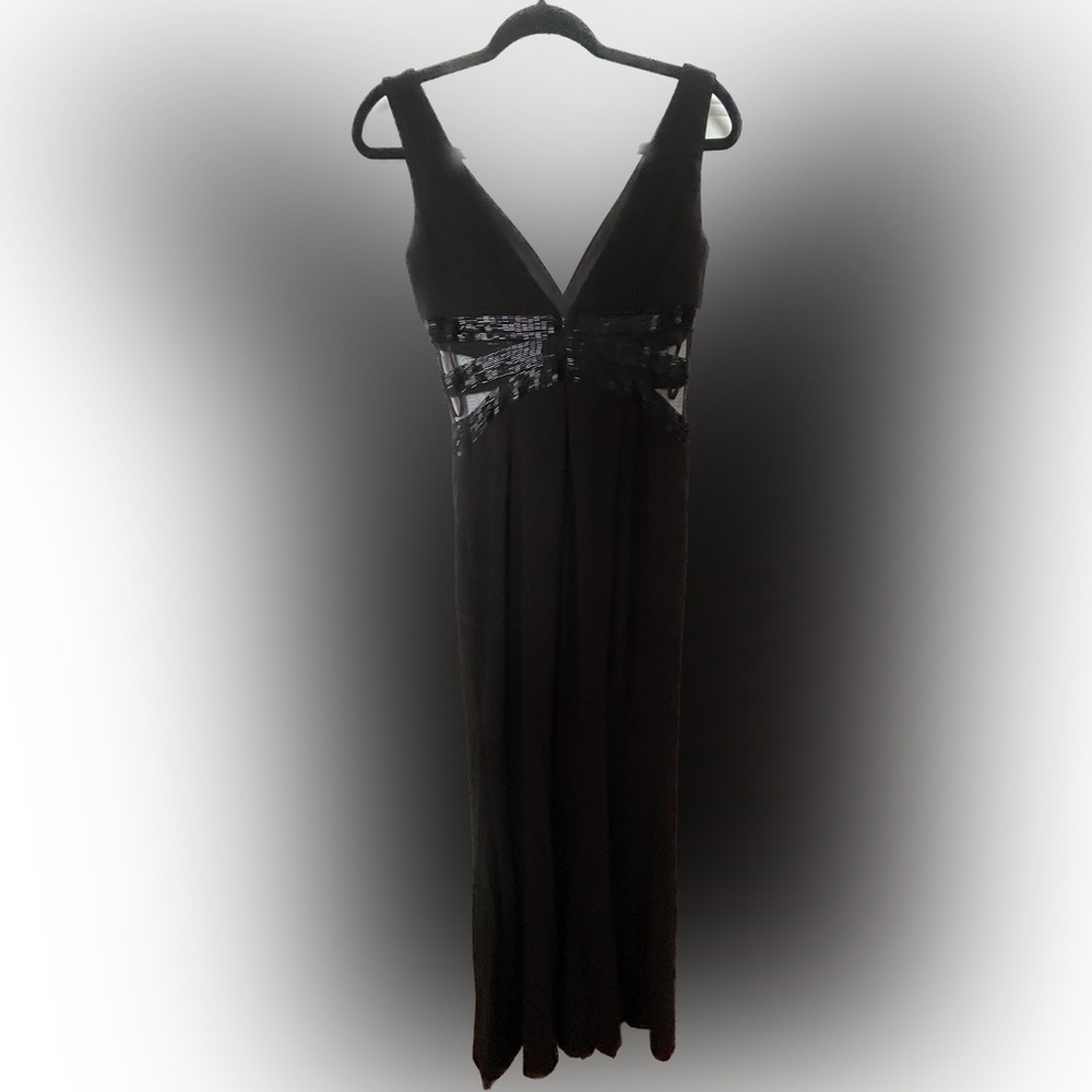 Elegant black gown with sheer panel and sequin embroidery details.
